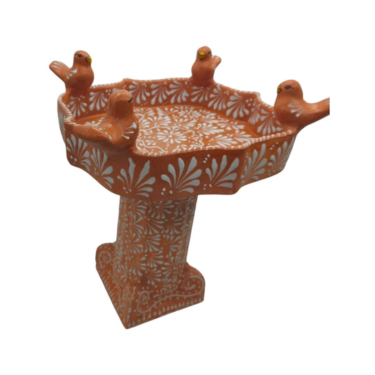 Detail view of floral white patterns and sculpted birds on brown Talavera bird bath