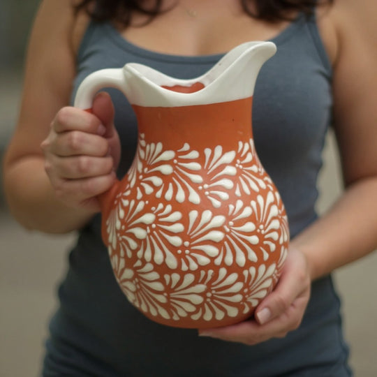 Talavera Brown & White Drinkware Set | Handmade Pitcher & Cups holding pitcher with floral design