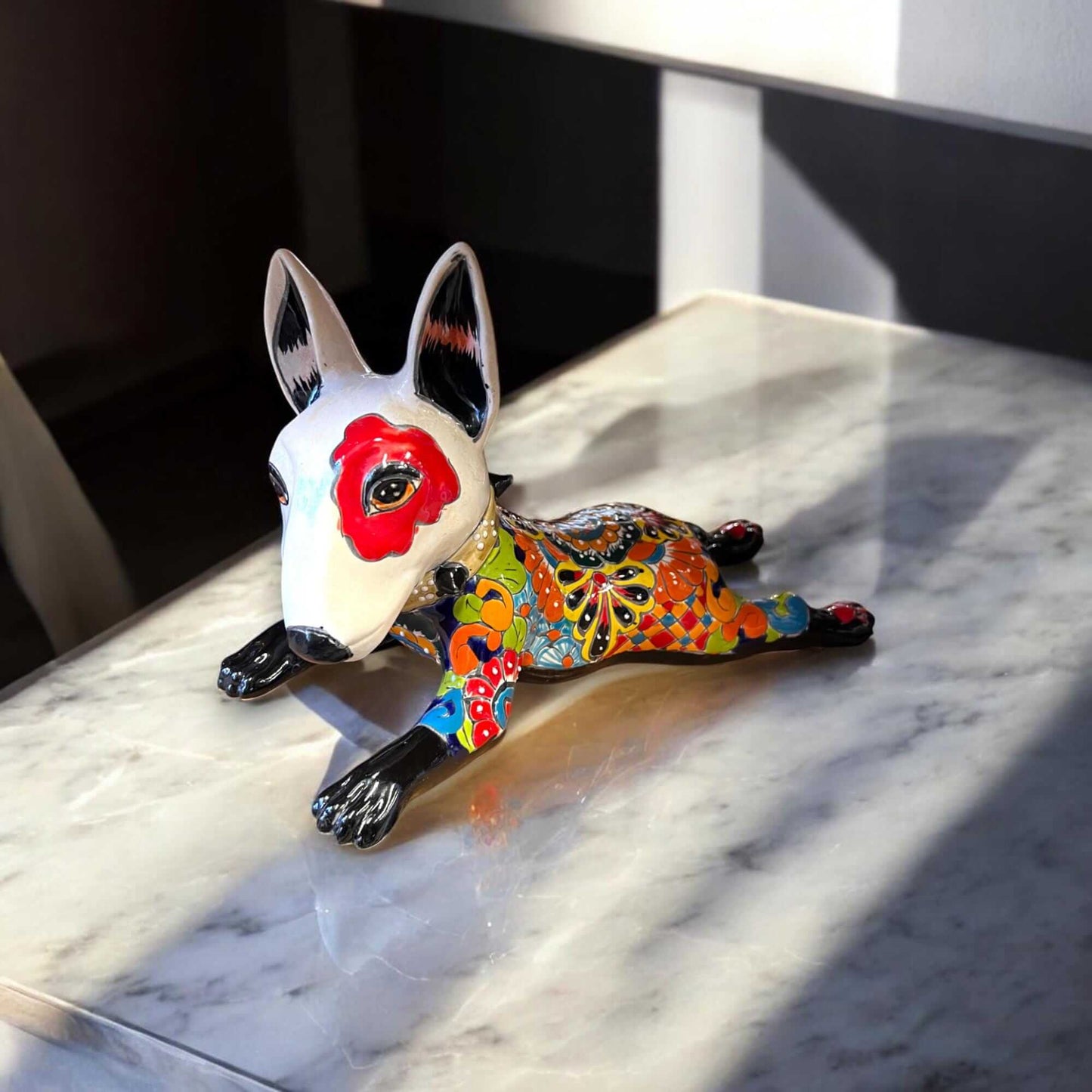 Talavera Bull Terrier Statue | Hand-Painted Colorful Dog Sculpture - handcrafted Mexican Talavera bull terrier with red eye patch and vivid floral patterns