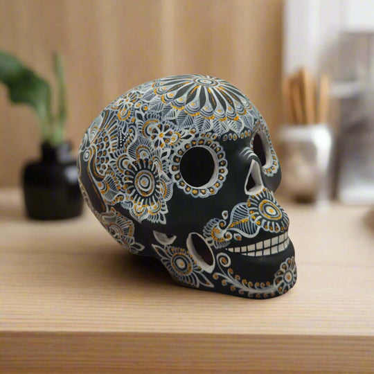 Talavera Calavera Skull | Hand-Painted Ceramic Decor - black skull with intricate white and gold floral motifs, hand-painted Mexican ceramic