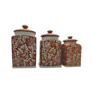 Front view of three brown and white Talavera canisters with lids