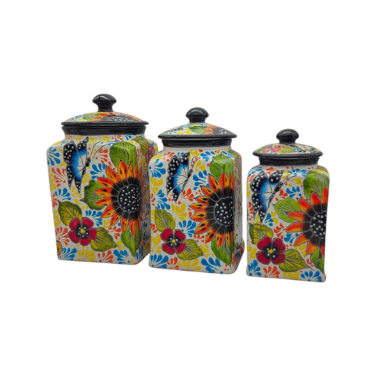 Colorful three-piece Talavera kitchen canister set with floral designs and black lids