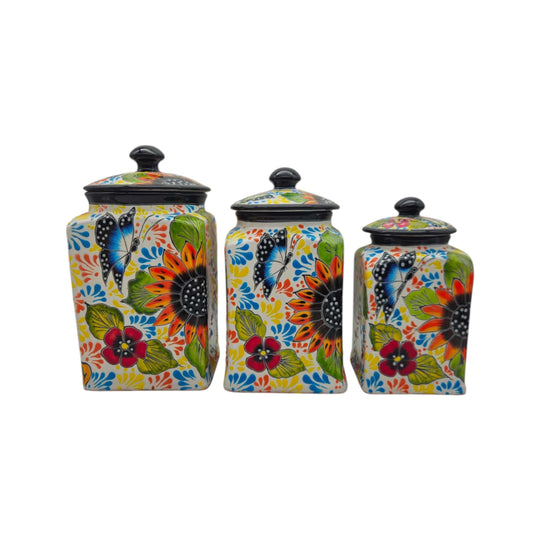 Talavera sunflower and butterfly canister trio shown against a white background