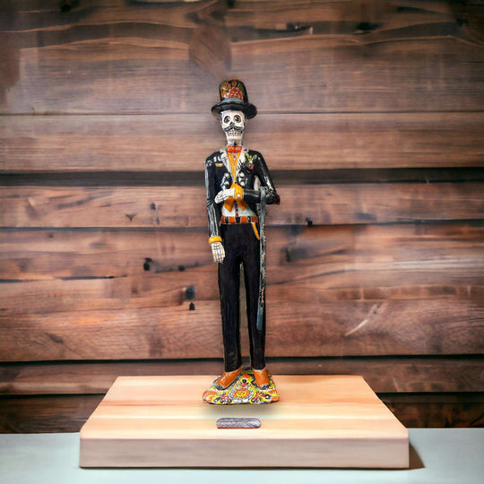 Talavera Catrin Statue | Hand-Painted Day of the Dead Skeleton Man - hand-painted Talavera Catrin in black suit with orange red accents on wooden stand