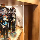 Talavera Catrin Statue | Hand-Painted Day of the Dead Skeleton Man displayed on wooden shelf, black suit with colorful hand-painted details