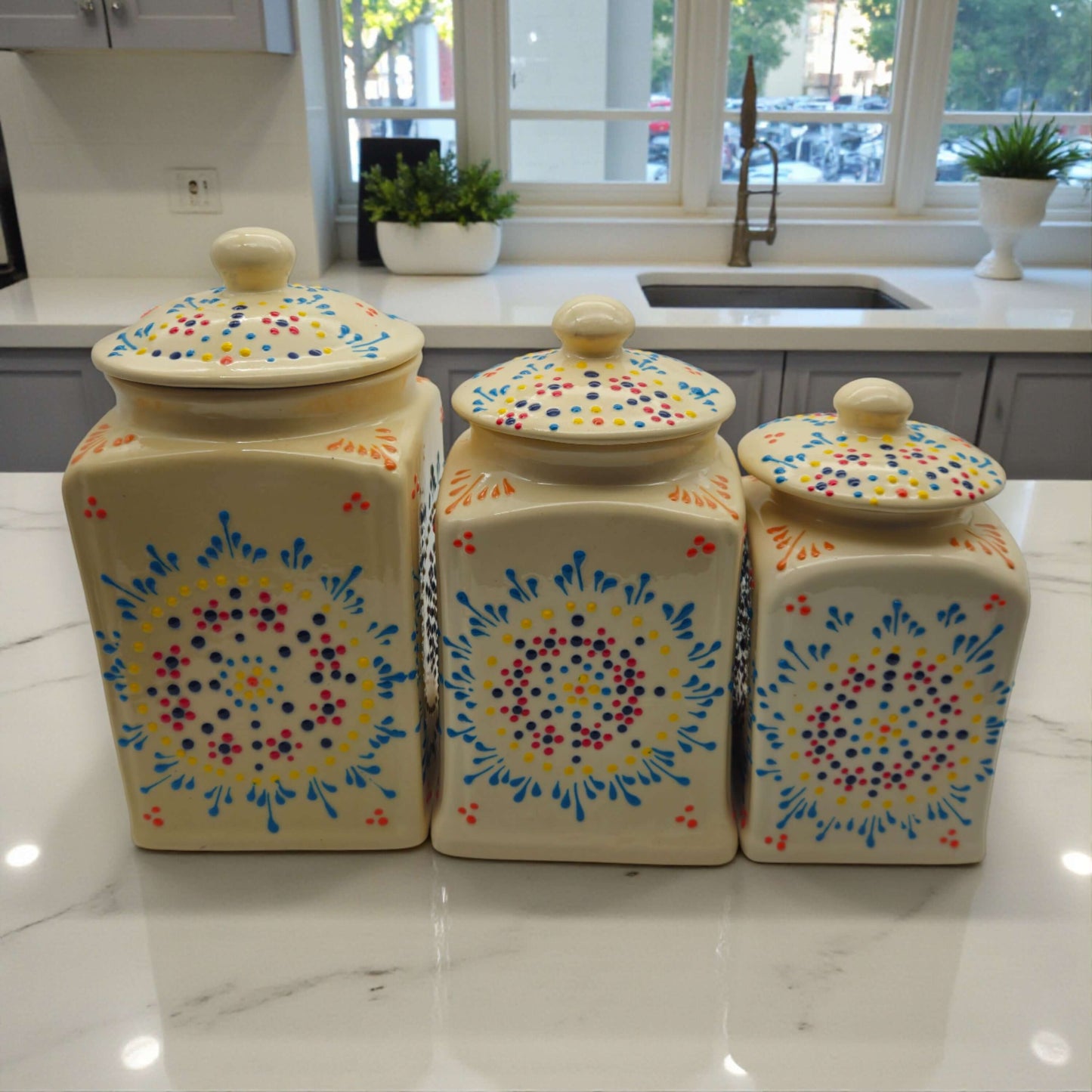 Talavera Ceramic Kitchen Canister Trio | White Multicolor Set handpainted ceramic canisters on marble countertop in bright kitchen