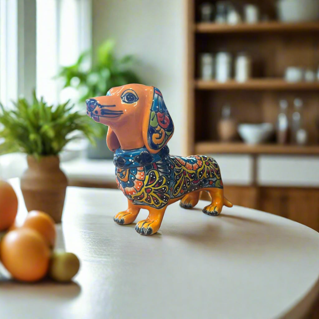 Talavera Dachshund Statue | Colorful Hand-Painted Dog Figurine on kitchen table, forest green base with peach floral hand-painted details