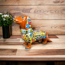 Talavera Dachshund Statue | Colorful Hand-Painted Dog Figurine - hand-painted orange and multicolor floral ceramic dachshund on wood table