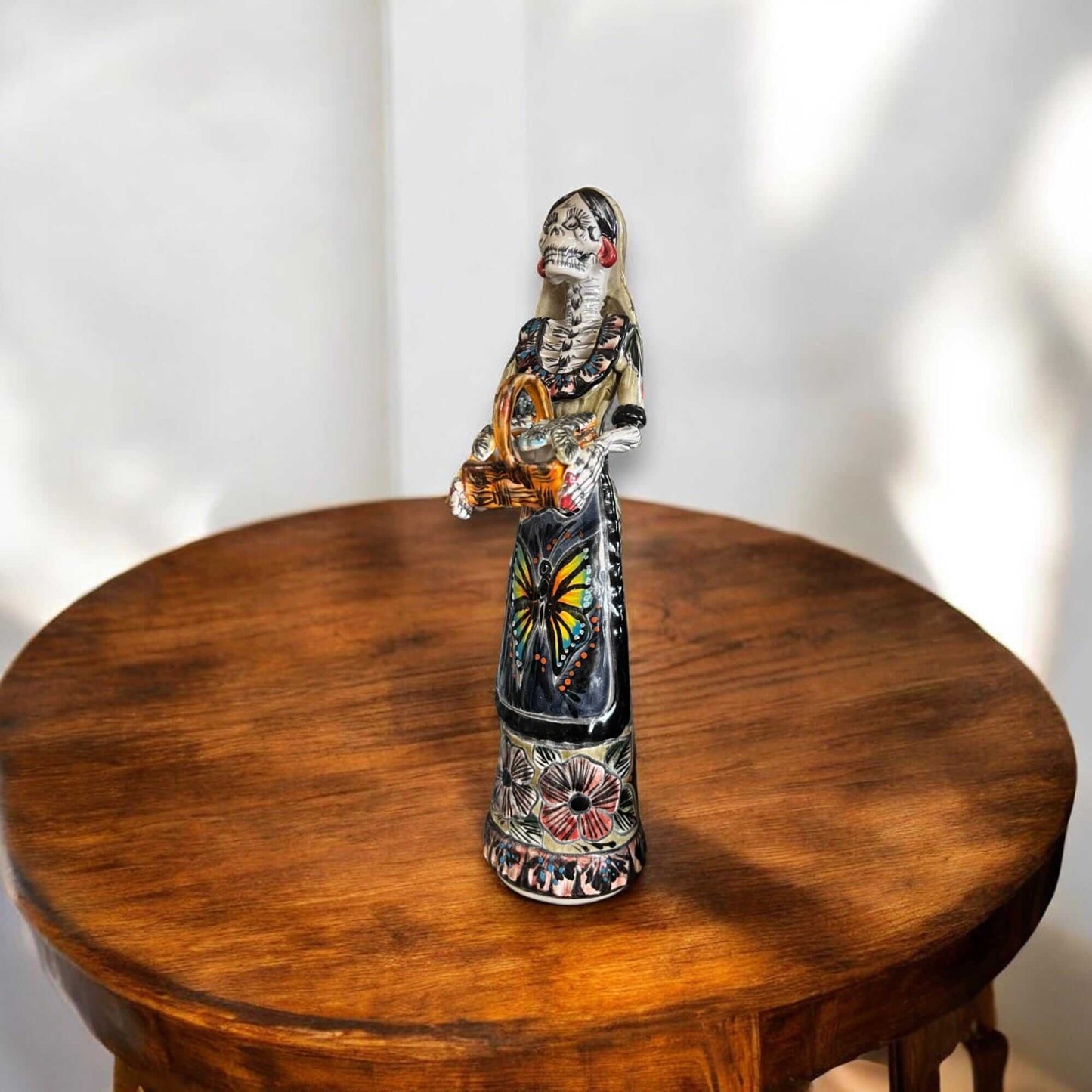 Talavera Day of the Dead Catrina | Pan Dulce Wedding Decoration - hand-painted Talavera Catrina statue on wooden table for wedding decor