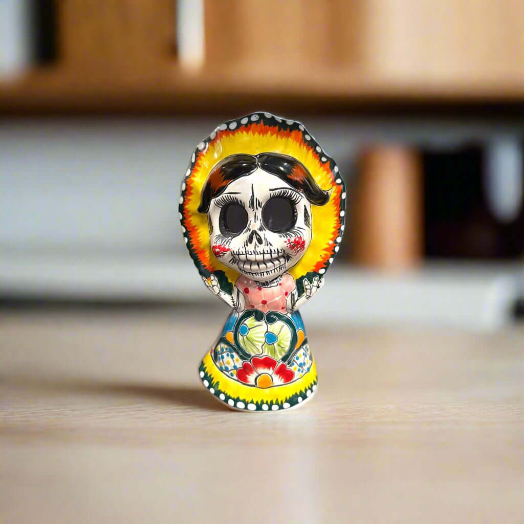 Talavera Skeleton Woman | Day of the Dead Figurine in Traditional Dress hand-painted 5" Talavera skeleton woman in folkloric dress and red-rimmed bonnet