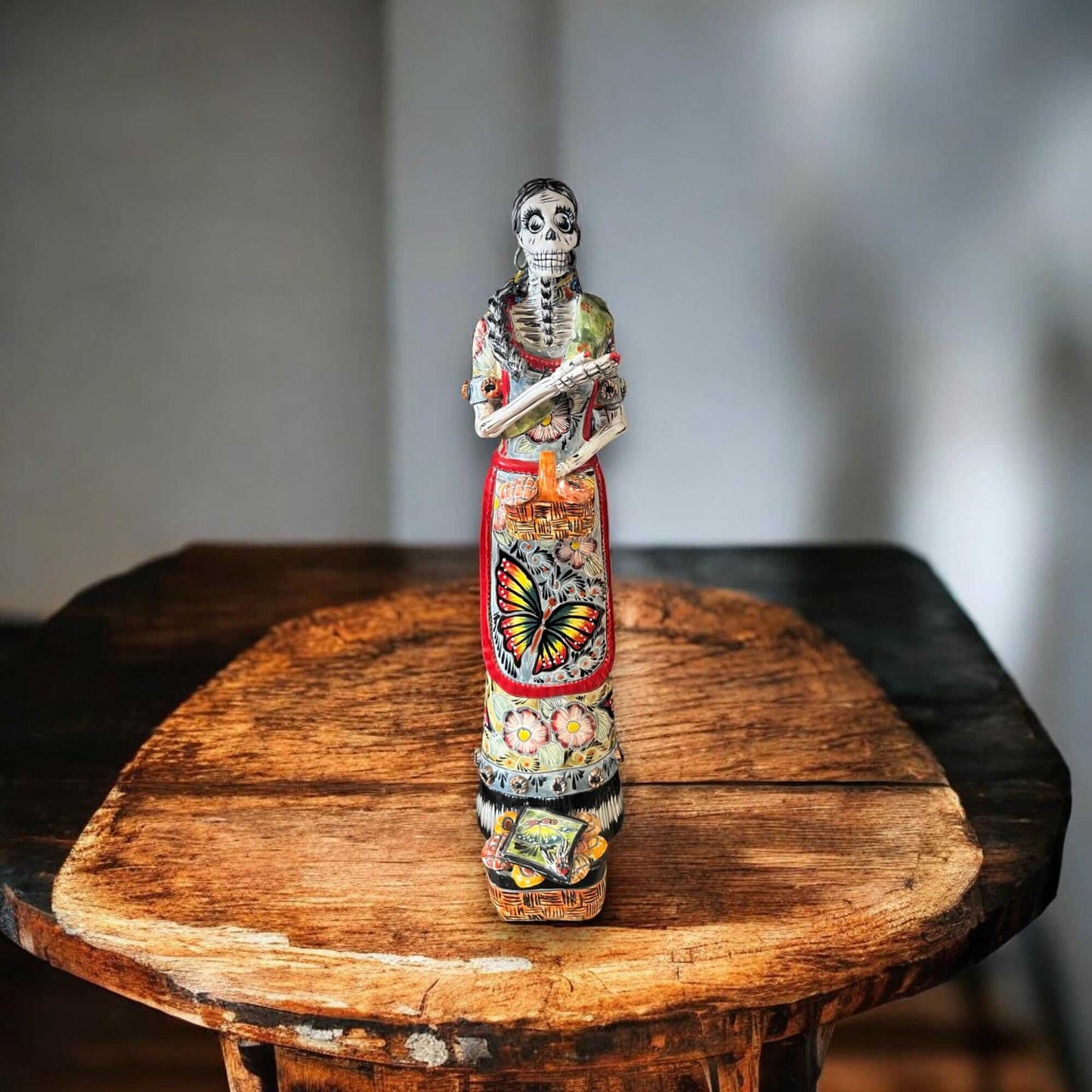 Talavera Day of the Dead Catrina | Pan Dulce Wedding Decoration - hand-painted Talavera Catrina statue on wooden table