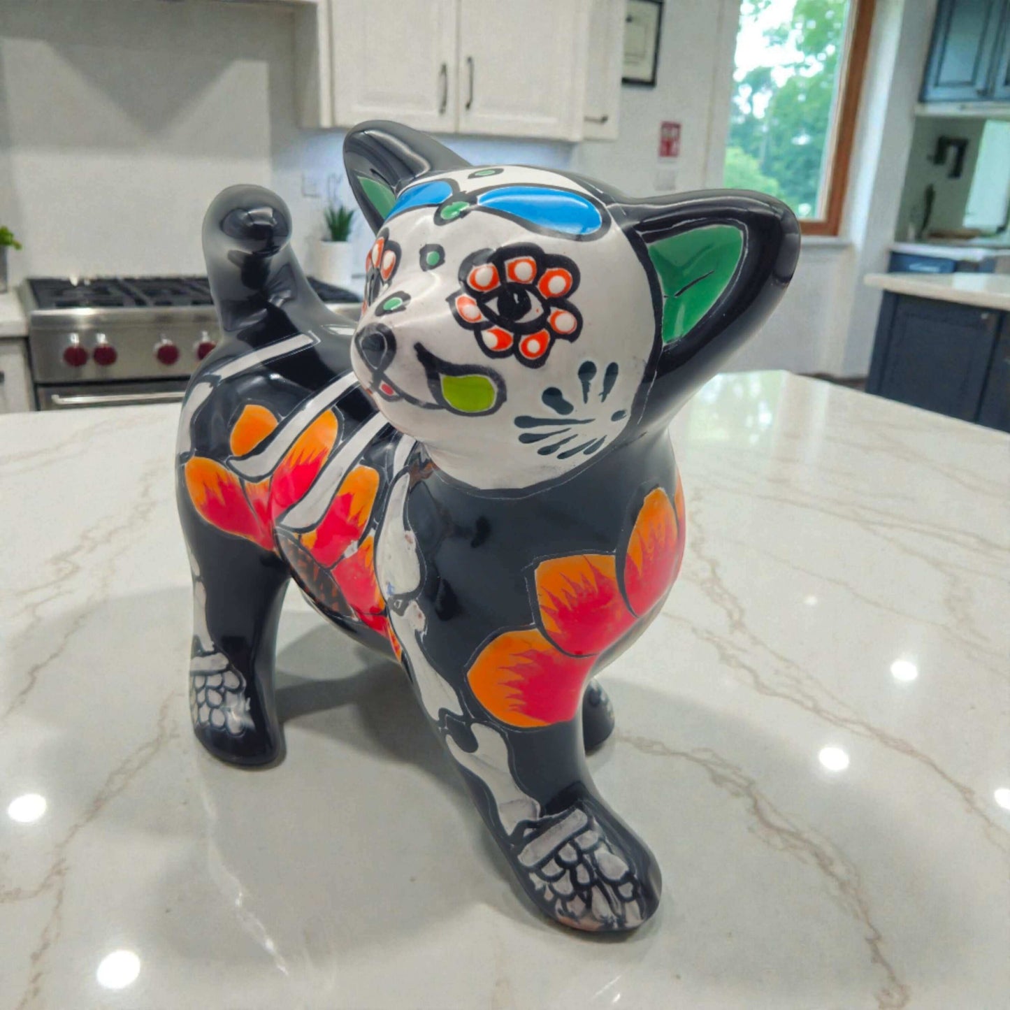 Talavera Chihuahua Figurine | Hand-Painted Day of the Dead Art - glossy black Talavera chihuahua with floral orange and green Day of the Dead motifs
