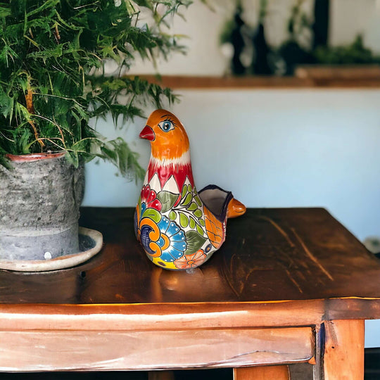 Talavera Dove Planter | Handcrafted Mexican Ceramic Bird Statue on wooden table with potted plant, handpainted colorful Talavera design