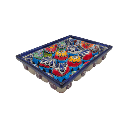 Angled view of a colorful Talavera ceramic egg holder showing its crate shape and decorative compartments