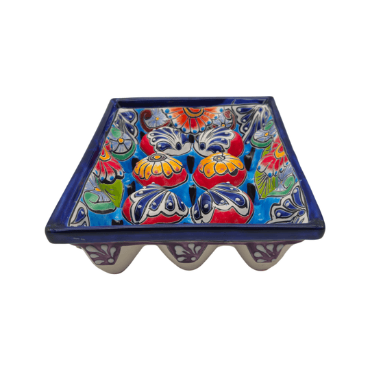 Front view of a colorful Talavera ceramic egg crate with floral designs and individual egg spaces