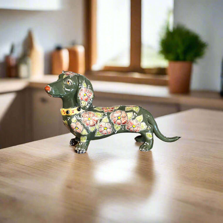 Talavera Dachshund Statue | Colorful Hand-Painted Dog Figurine - hand-painted forest green Talavera dachshund with peach flowers on wooden table