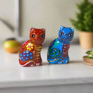 Set of 2 Talavera Cat Salt and Pepper Shakers | Hand-Painted Ceramic — hand-painted red and blue Talavera cat shakers on table
