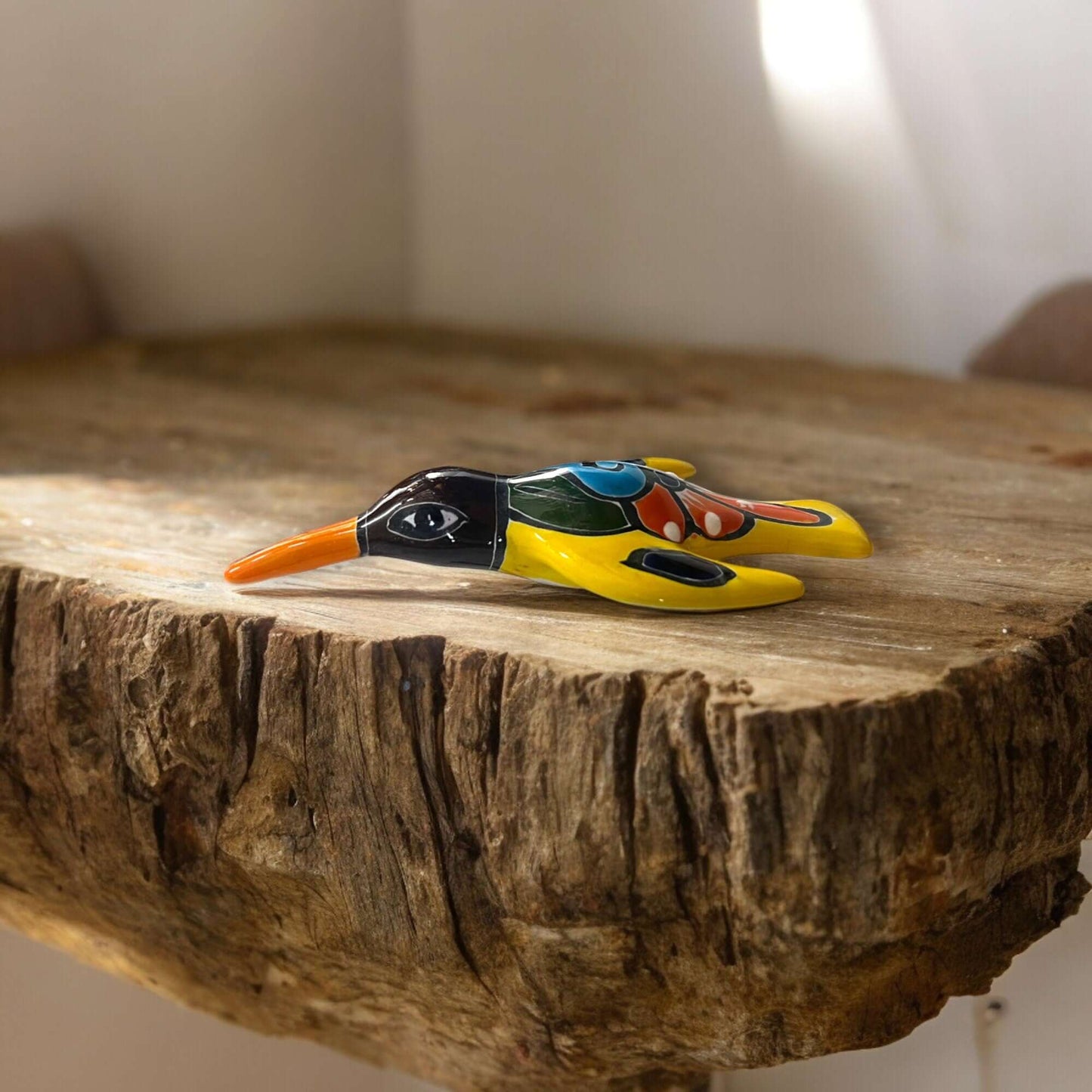 Talavera Hummingbird Wall Art | Mexican Hand-Painted Bird Decor - hand-painted red, navy, orange, green Talavera hummingbird on rustic wood shelf