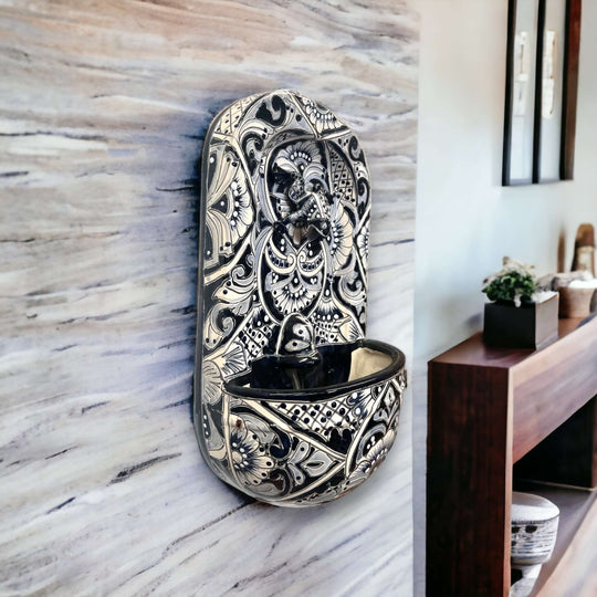 Talavera Wall Fountain | Handcrafted Mexican Ceramic Water Feature - black and white hand-painted ceramic wall fountain mounted in modern entryway