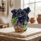 Blue Talavera heart figurine with colorful floral decoration on a tabletop