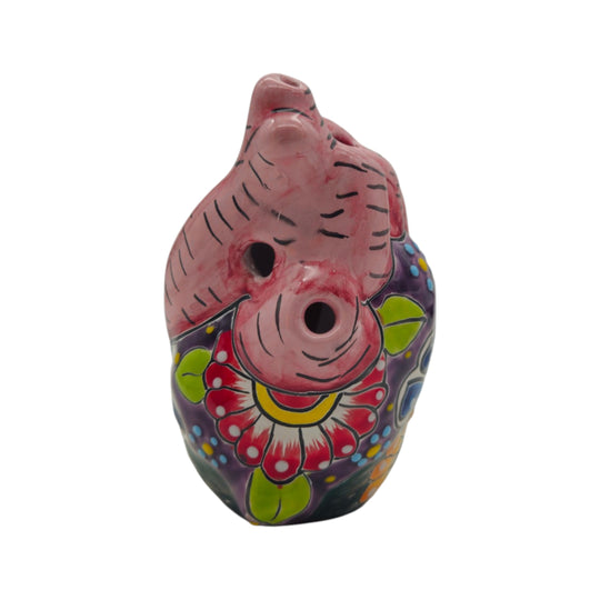 Pink floral side of a hand-painted Talavera heart figurine on white