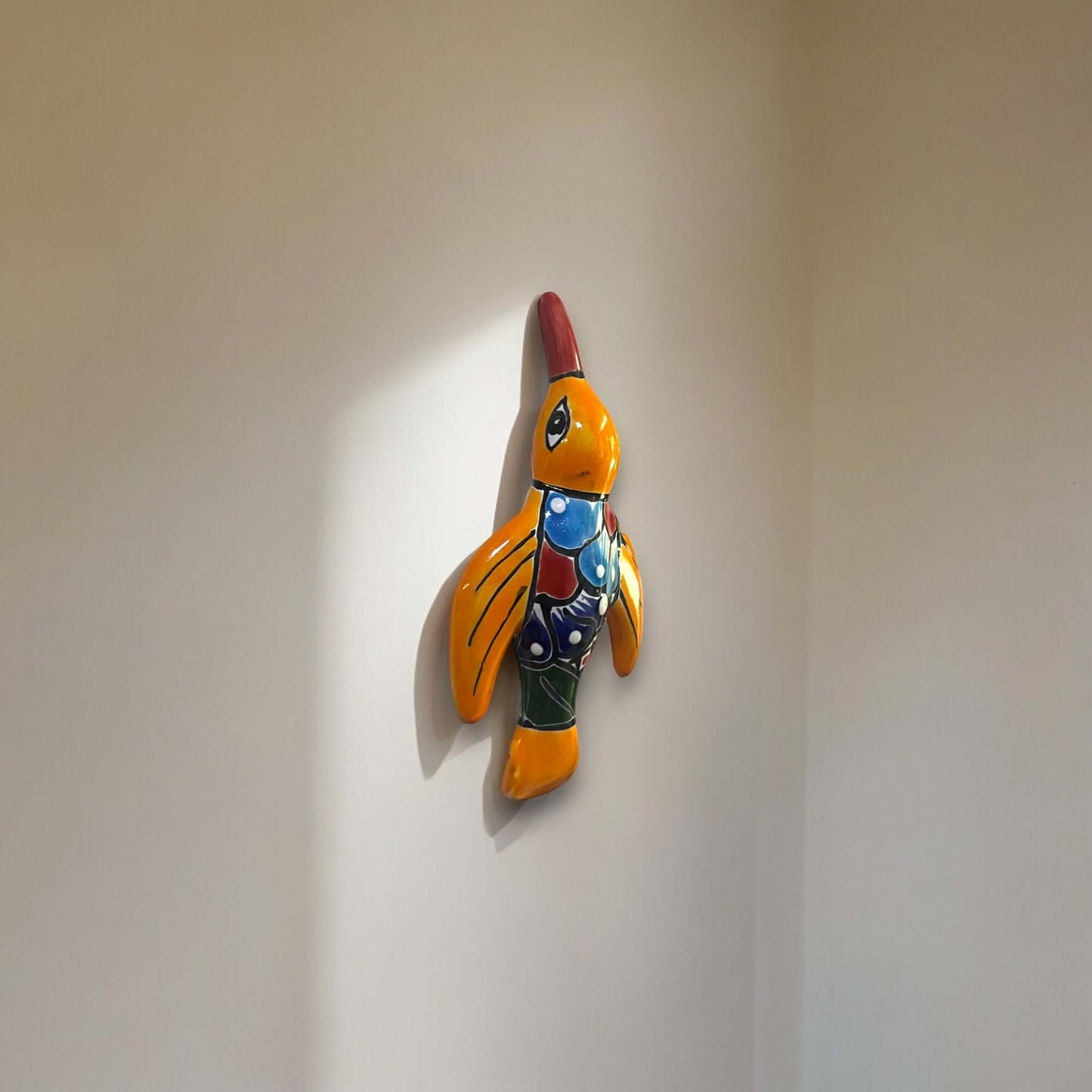 Talavera Hummingbird Wall Art | Mexican Hand-Painted Bird Decor wall-mounted red and yellow hand-painted Talavera hummingbird with floral details
