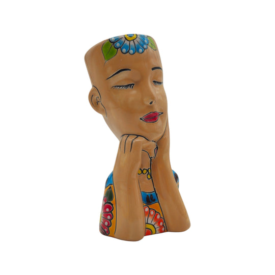 Front view of a brown Talavera lady face planter on a white background