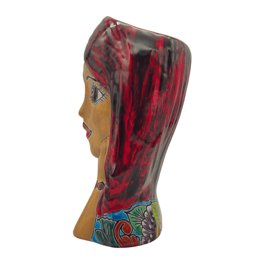 Side profile of a Talavera lady face planter showing floral artwork and sculptural form