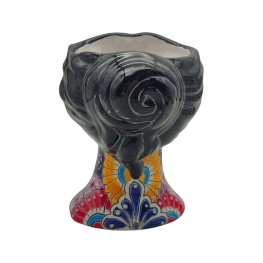 Back view of a Talavera lady head planter showing floral decoration on the base