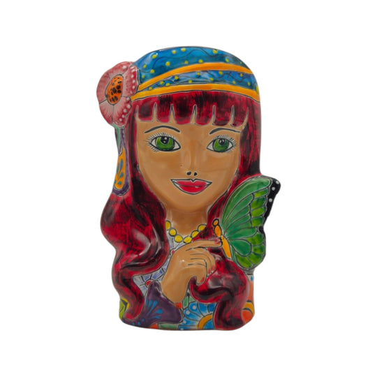 Front view of a colorful Talavera lady head planter with floral details