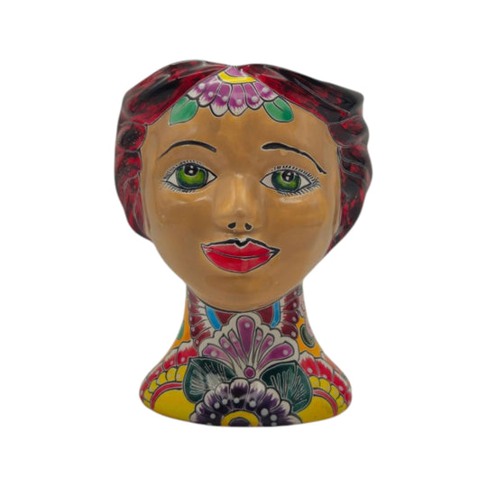 Front view of a Talavera lady head planter with green eyes and colorful flowers