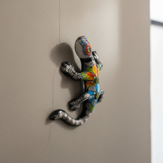 The Talavera Hub colorful ceramic lizard figurine with hand-painted floral patterns and skeletal details, Day of the Dead decor.