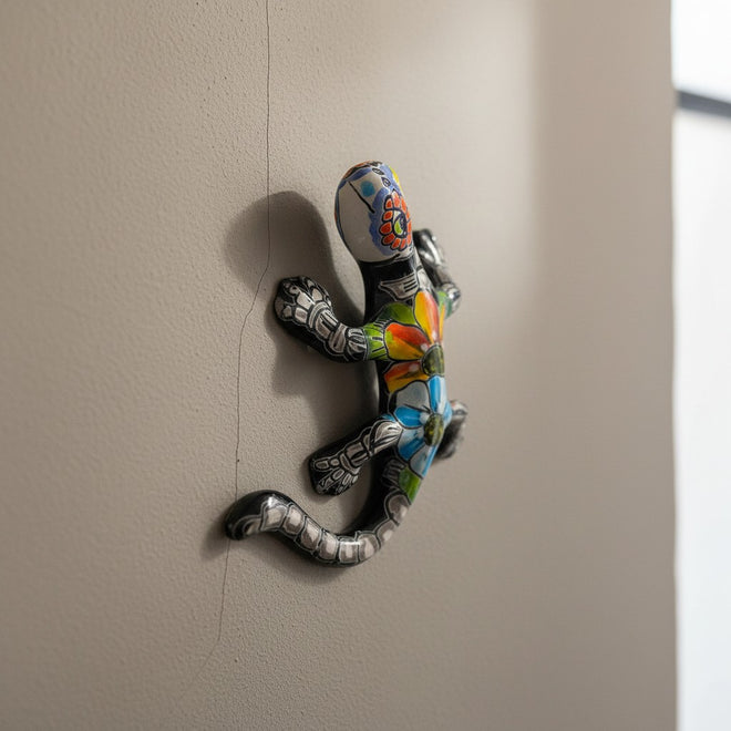 The Talavera Hub colorful ceramic lizard figurine with hand-painted floral patterns and skeletal details, Day of the Dead decor.
