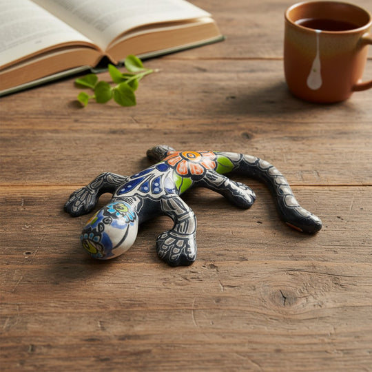 The Talavera Hub ceramic lizard figurine with floral patterns in blue, green, orange, and red. Day of the Dead decor.