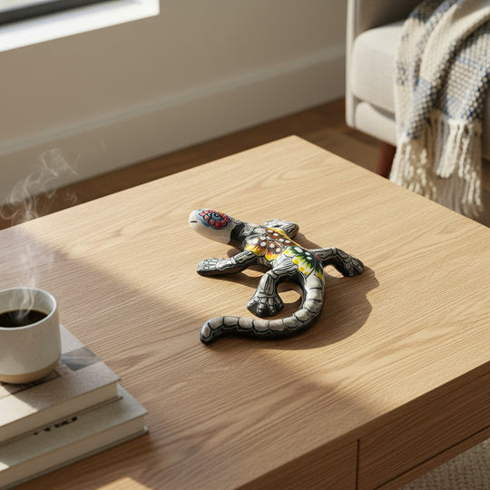 The Talavera Hub black ceramic lizard figurine with colorful floral and skeletal details. Hand-painted art from Mexico.
