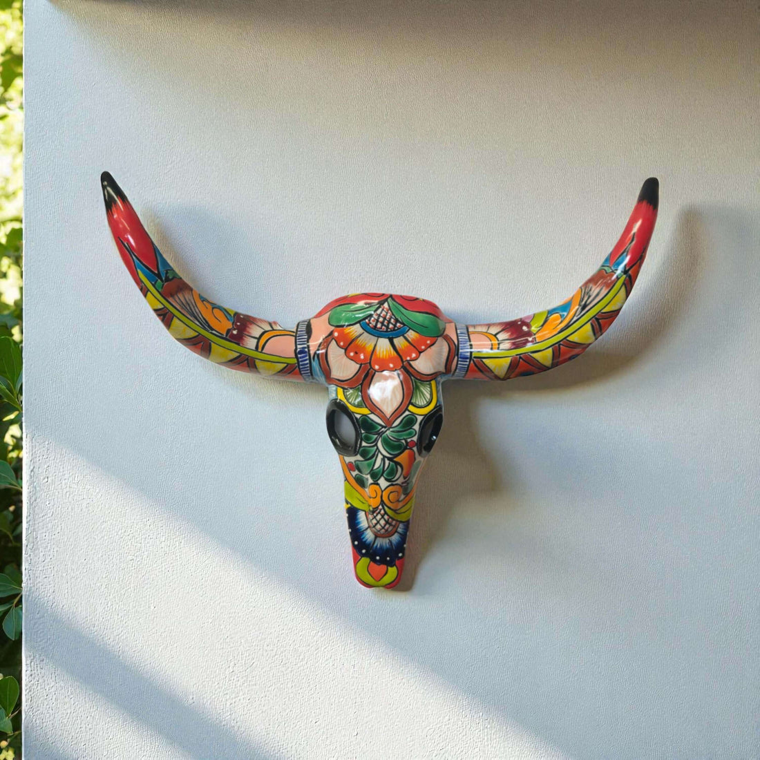 Talavera Longhorn Wall Decor | Handcrafted Mexican Bull Skull Art - hand-painted colorful Talavera ceramic longhorn mounted on white wall