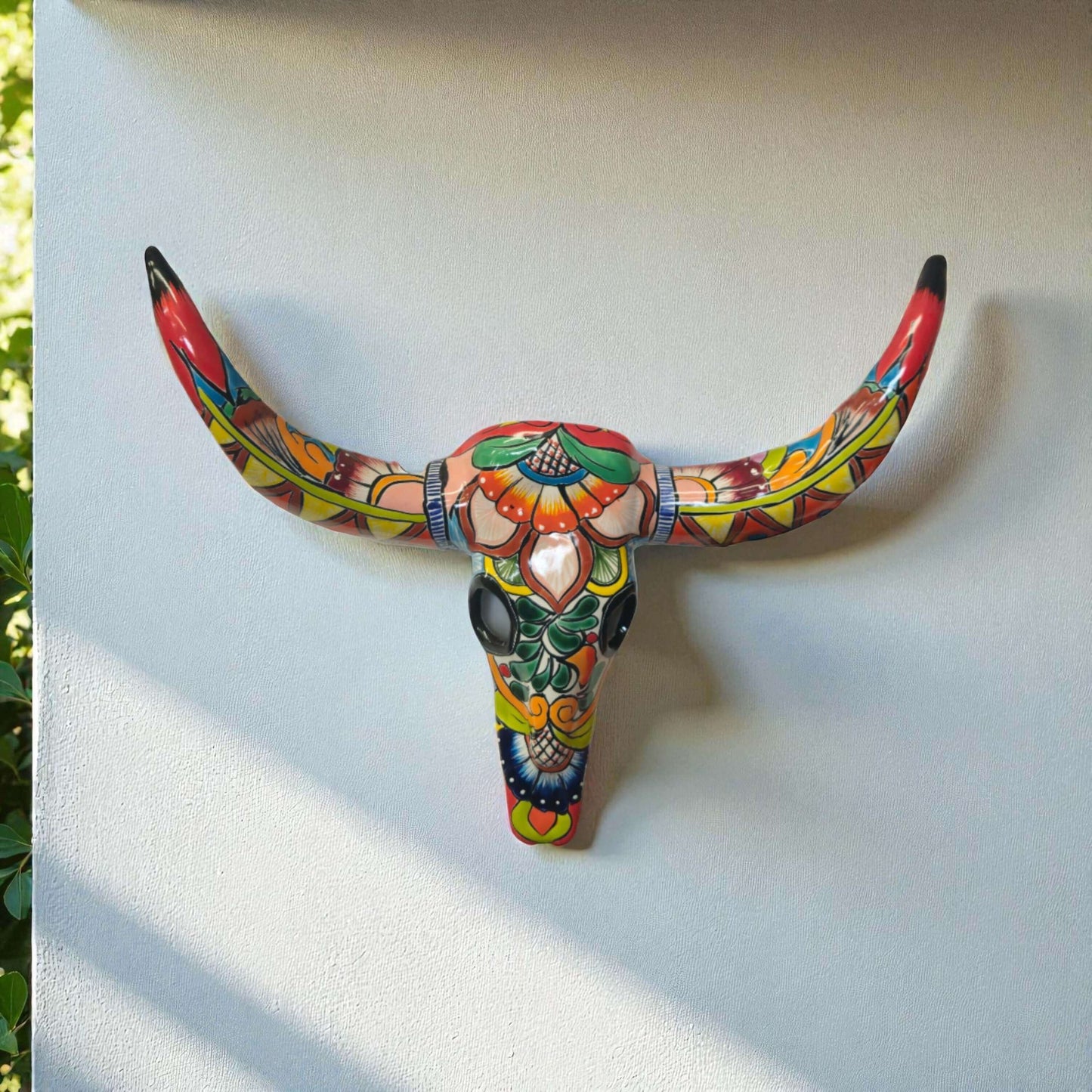 Talavera Longhorn Wall Decor | Handcrafted Mexican Bull Skull Art - hand-painted colorful Talavera ceramic longhorn mounted on white wall