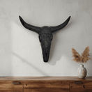 Black Talavera longhorn bull skull wall decor displayed above a console