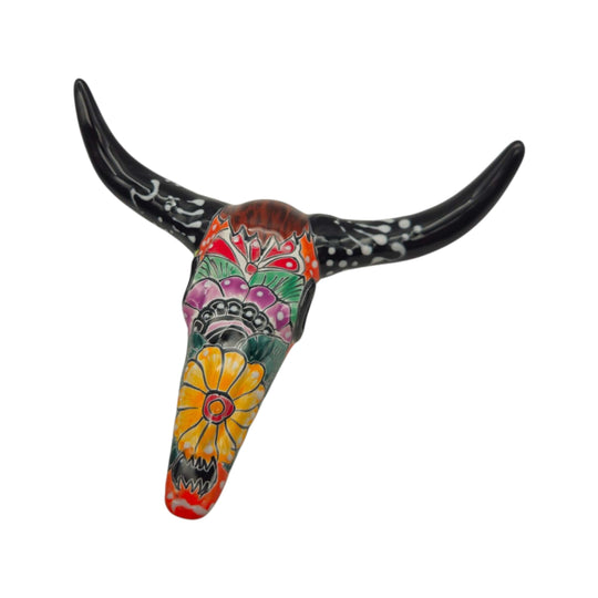 Detail view of black-horned Talavera longhorn wall art with colorful floral painting