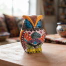 Talavera owl figurine with colorful floral details displayed on a tabletop