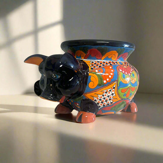 Talavera Pig Planter | Colorful Hand-Painted Mexican Animal Pot sitting on a sunlit surface with bold floral and geometric Talavera patterns