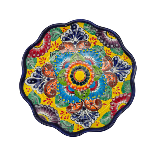 Front view of a colorful yellow Talavera plate with a floral hand-painted design