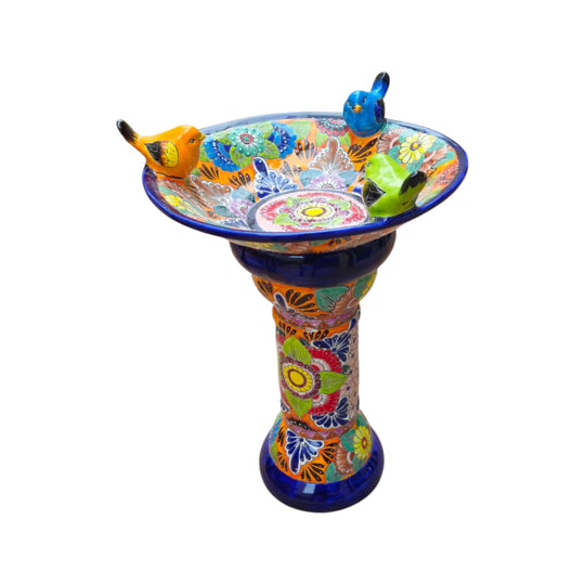 Colorful Talavera bird bath with blue pedestal and bird figures, angled view