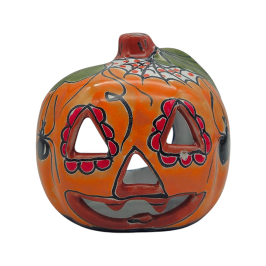 Front detail of an orange Talavera Jack-O'-Lantern statue with colorful painted trim