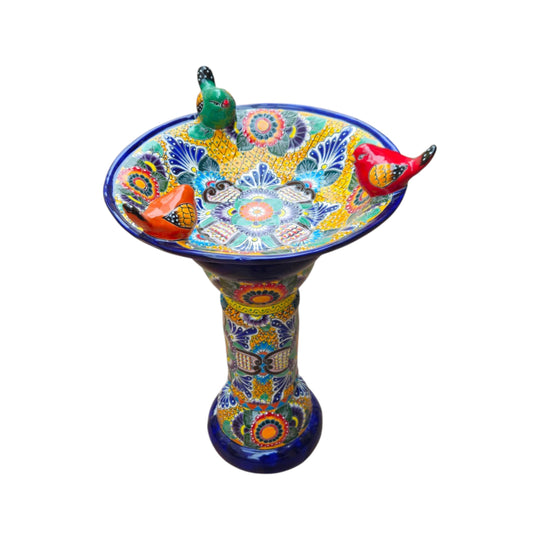 Talavera bird bath showing its floral patterned basin and three perched birds