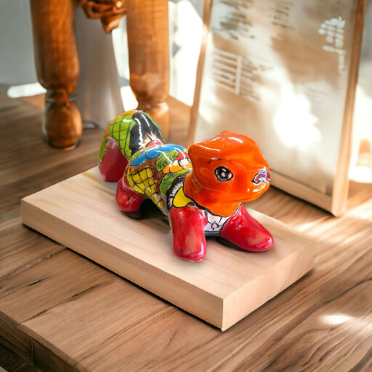 Talavera Squirrel Statue | Colorful Hand-Painted Mexican Figurine on wooden display, vibrant red body with multicolor floral accents