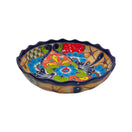 Colorful hand-painted Talavera scalloped ceramic bowl on a white background
