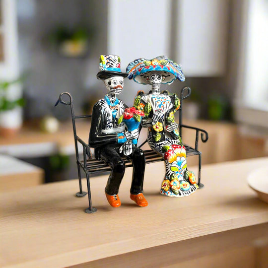Talavera Skeleton Couple on Bench | Day of the Dead Mexican Decor hand-painted Talavera skeleton couple sitting on a wrought iron bench