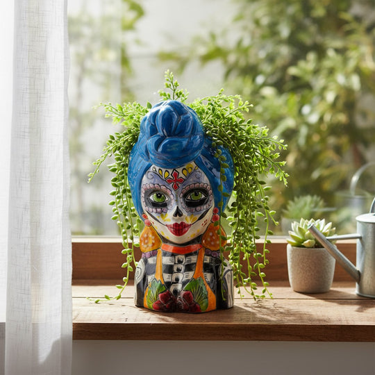 The Talavera Hub ceramic lady skull planter with blue hair, green eyes, and colorful Day of the Dead face paint.