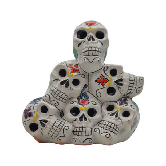 Front view of a colorful Talavera stacked skulls ceramic statue